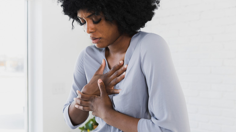Woman holding onto her heart