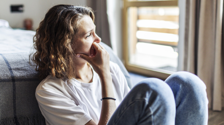 Forlorn woman gazing out the window