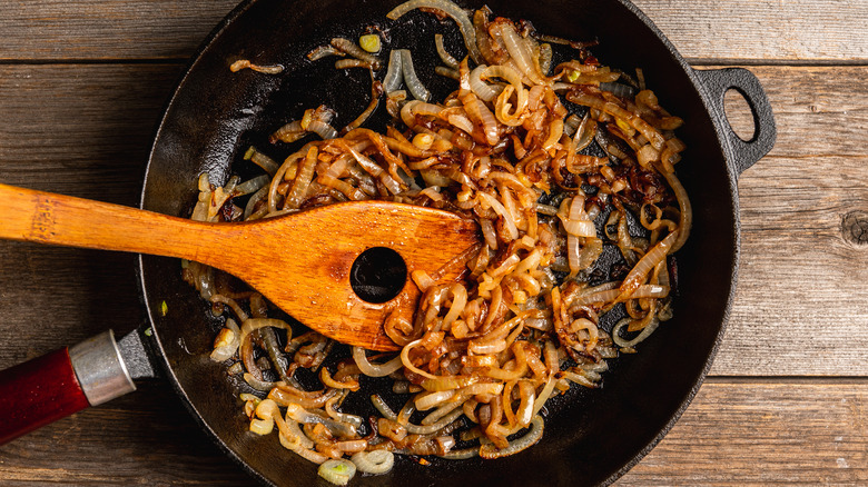 Onions being cooked in a cast iron skillet