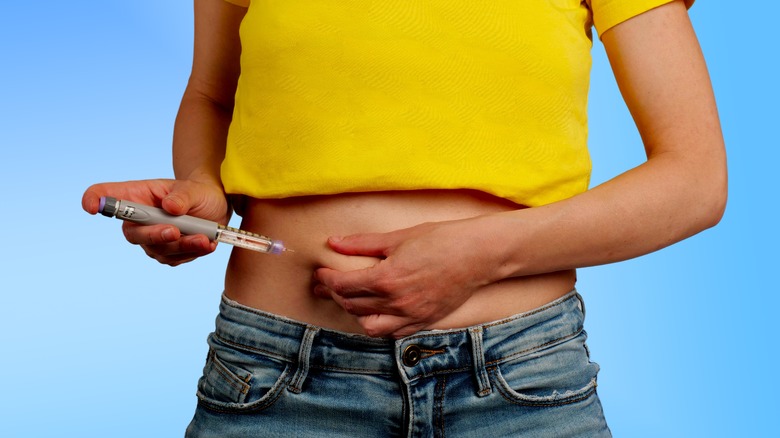 person with diabetes injecting insulin