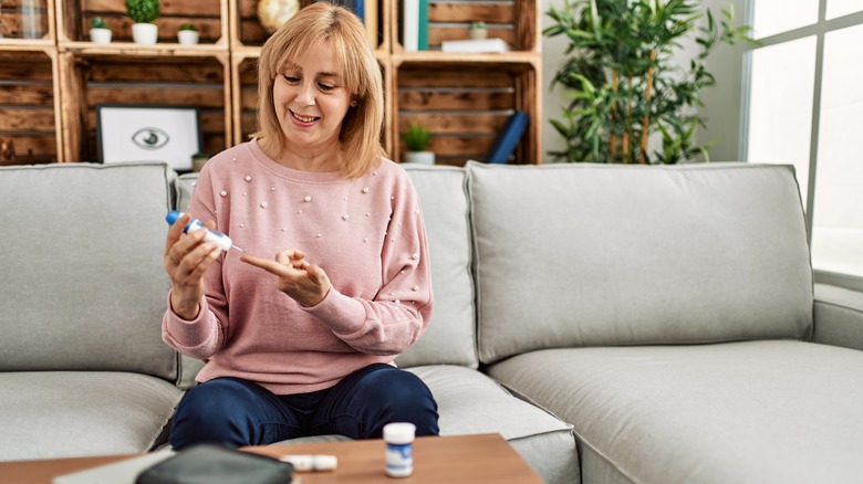 woman testing glucose levels at home