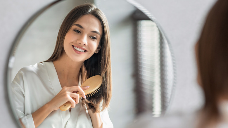 Woman combing hair