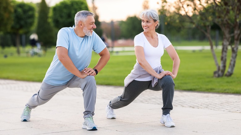 middle-aged couple doing lunges