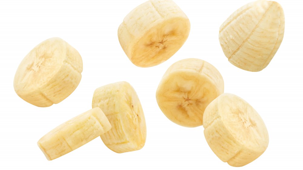 Flying banana slices on a white background