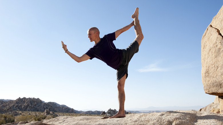 man doing dancer's pose outdoors