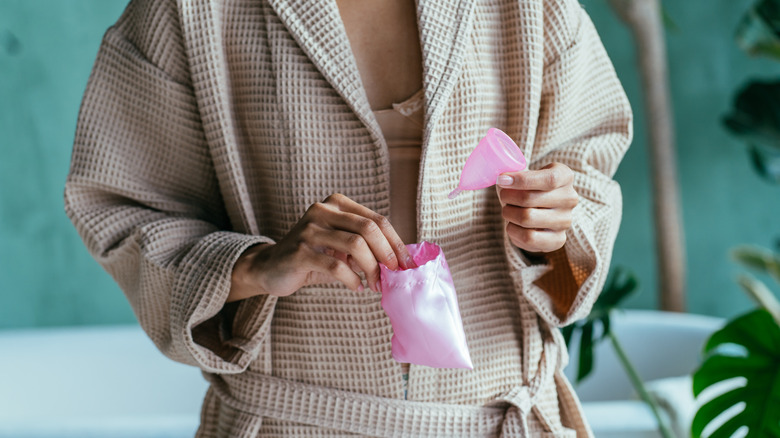 Woman holding a menstrual cup