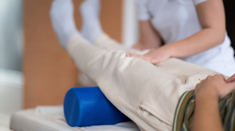 Person using a foam roller for physiotherapy