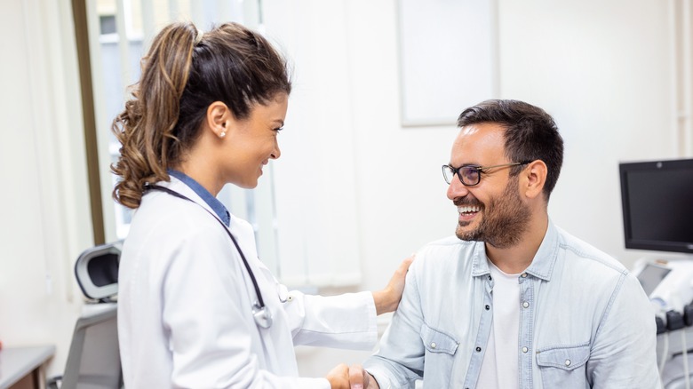 doctor shaking happy patient's hand