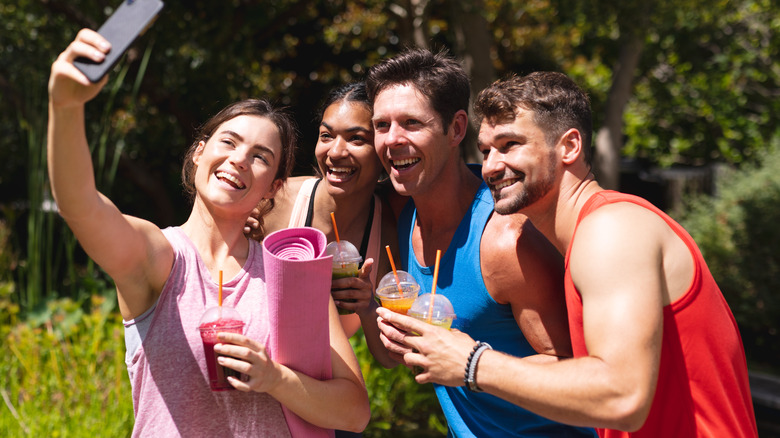 Group of individuals drinking post workout beverages