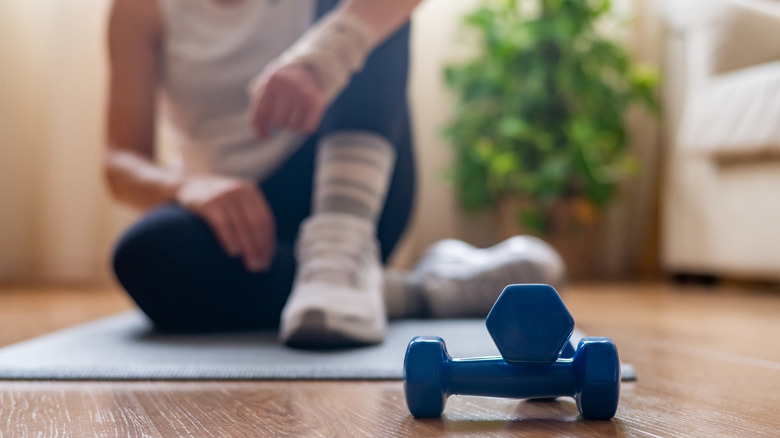woman in background and small weights in foreground