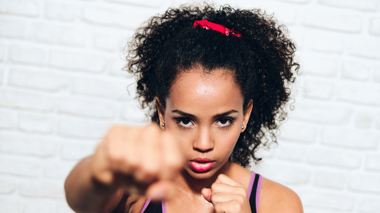 Woman working out and punching 