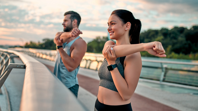 Couple stretching outdoors