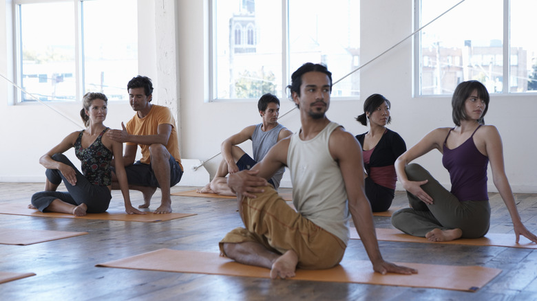 A yoga class doing seated twists