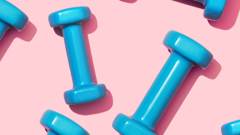 blue dumbbells on pink blackground