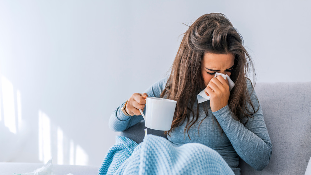 Sick woman drinking tea