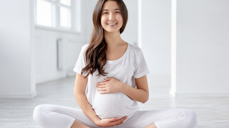 Pregnant Asian woman smiling