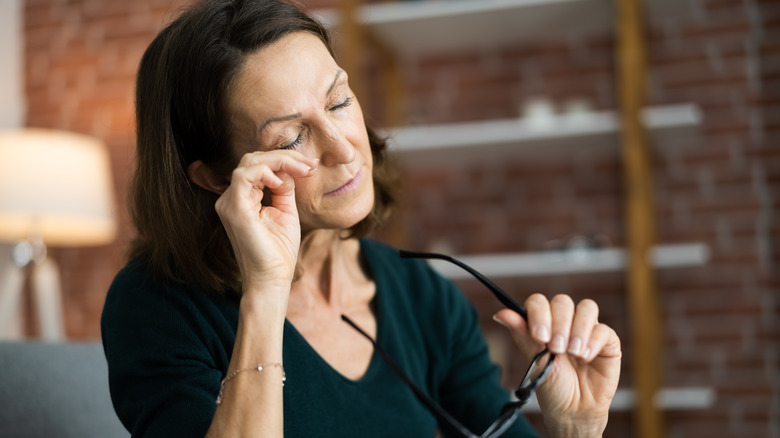 A woman wiping her eye