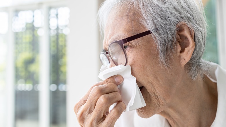 Older woman using tissue