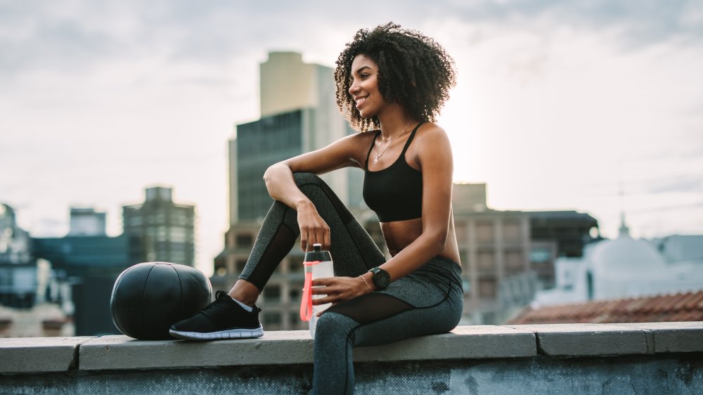 Woman drinking water after workout