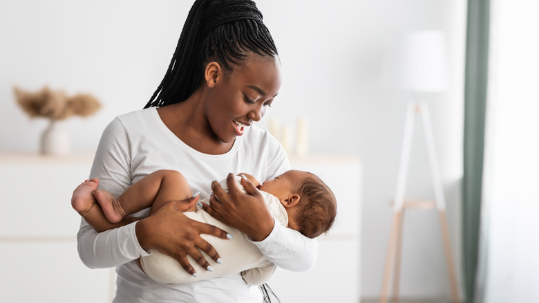 woman smiling at her baby