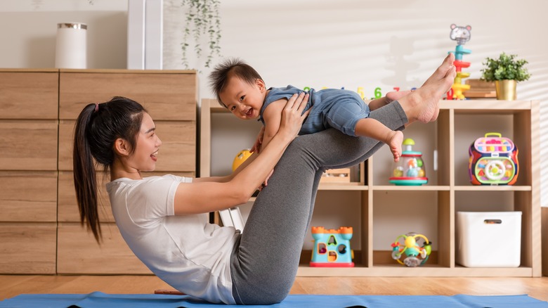 mother doing yoga with her baby