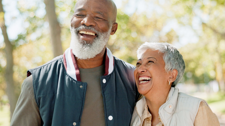 mature couple laughing together outside