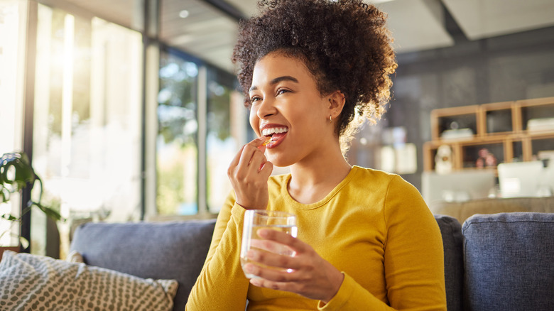 Woman taking a supplement