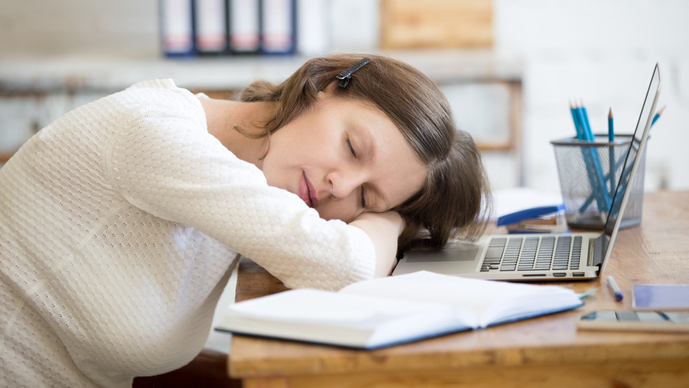 woman snoozing at desk