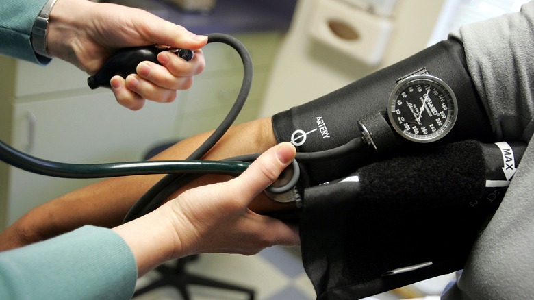 A healthcare professional checks the blood pressure of a patient in the office