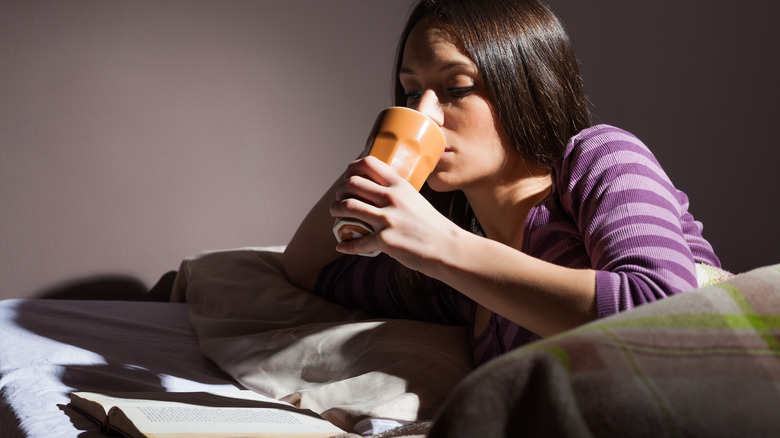 a person on their phone and getting ready for bed