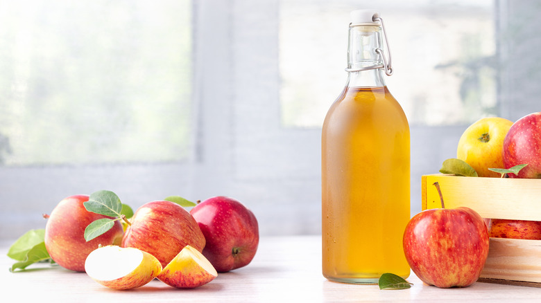 a glass bottle of apple cider vinegar