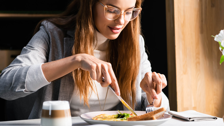 Woman eating an omelet