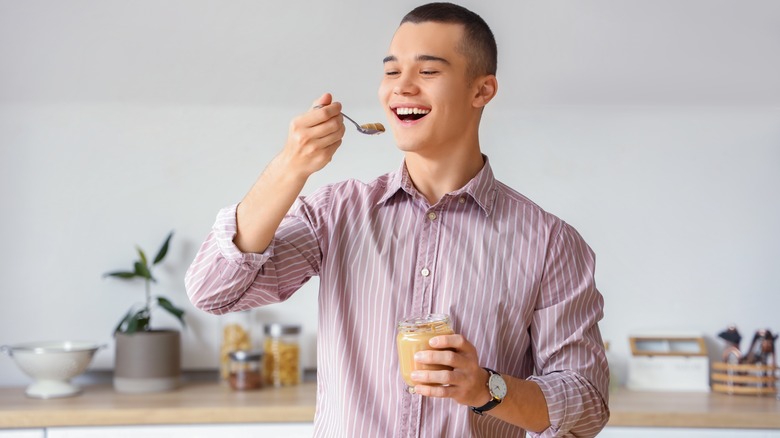 man eating peanut butter