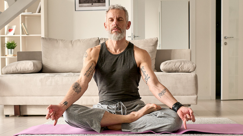 seated older man meditating 