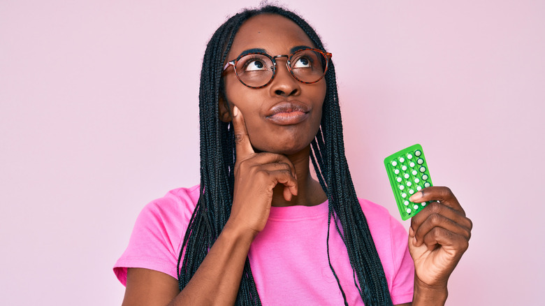 Woman holding birth control