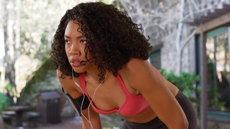 Woman in earbuds readying for workout
