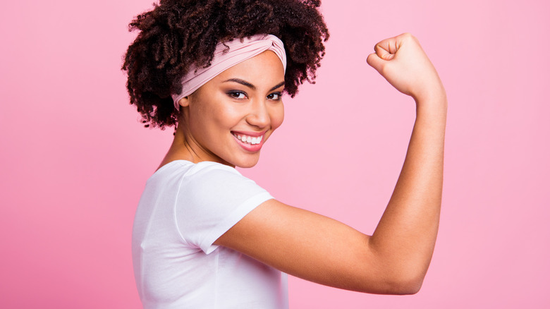 Woman flexing biceps and triceps