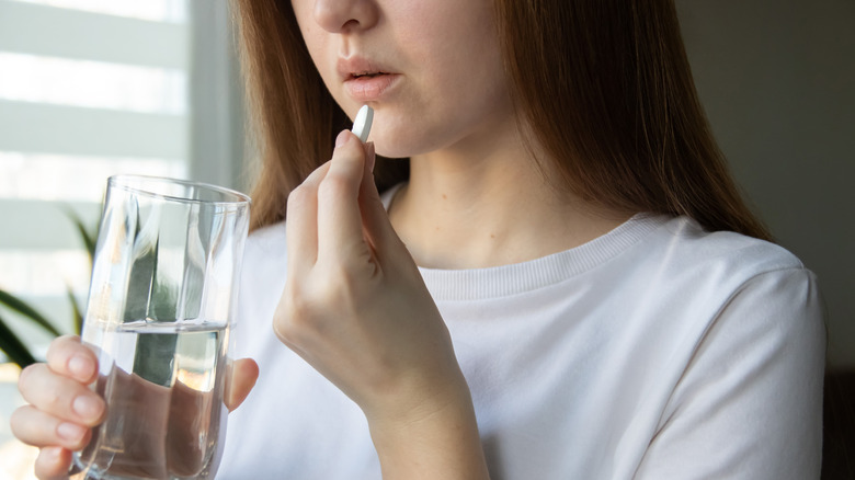 woman taking magnesium supplement