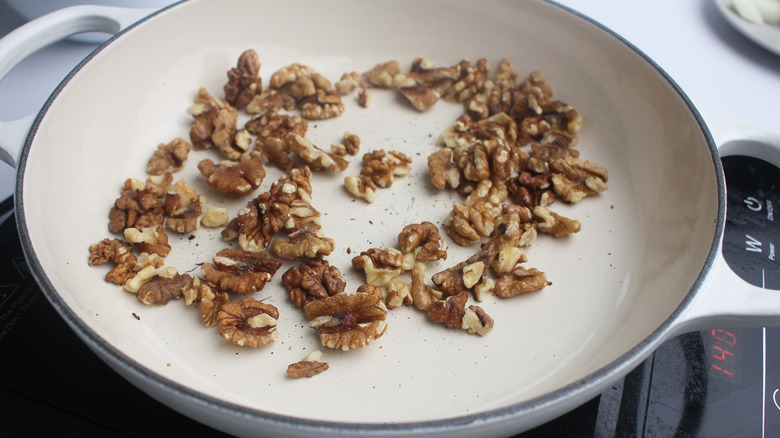 Walnuts toasting in a pan