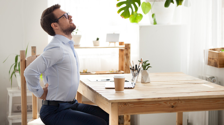 man feeling pain while sitting