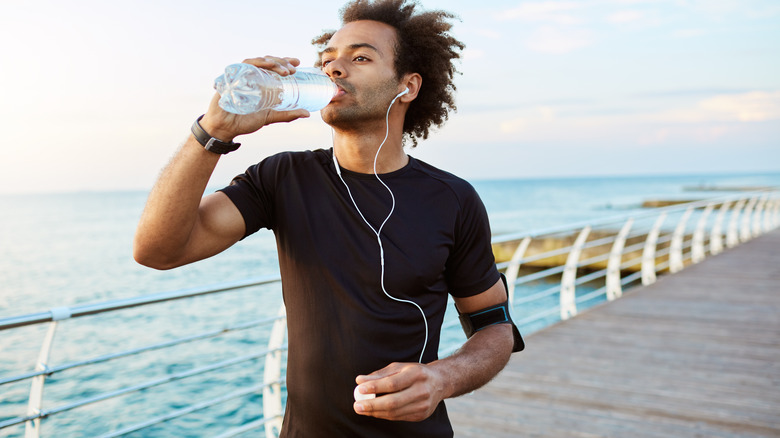 man drinking from water bottle