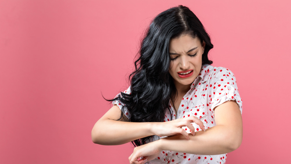 woman scratching itchy arm