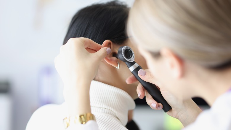 otolaryngologist looking in patient's ear
