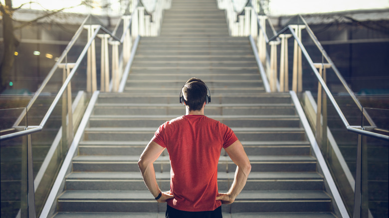 Man looking at flight of stairs