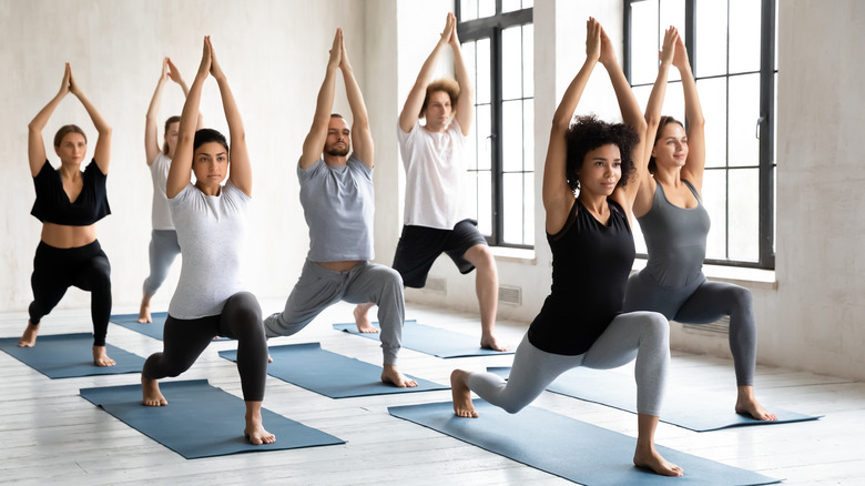 yoga class warriors doing poses