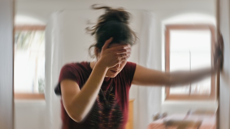 person holding forehead suffering from migraine