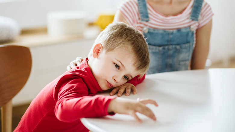 Kid with ADHD sitting at table