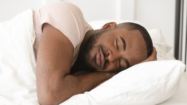 A man asleep in bed