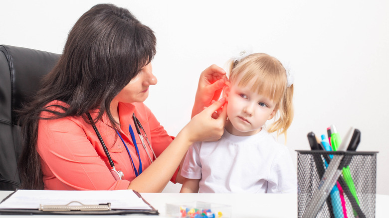 Doctor examining child with an ear infection