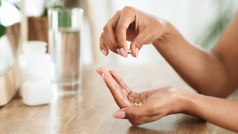 Black woman holding supplements